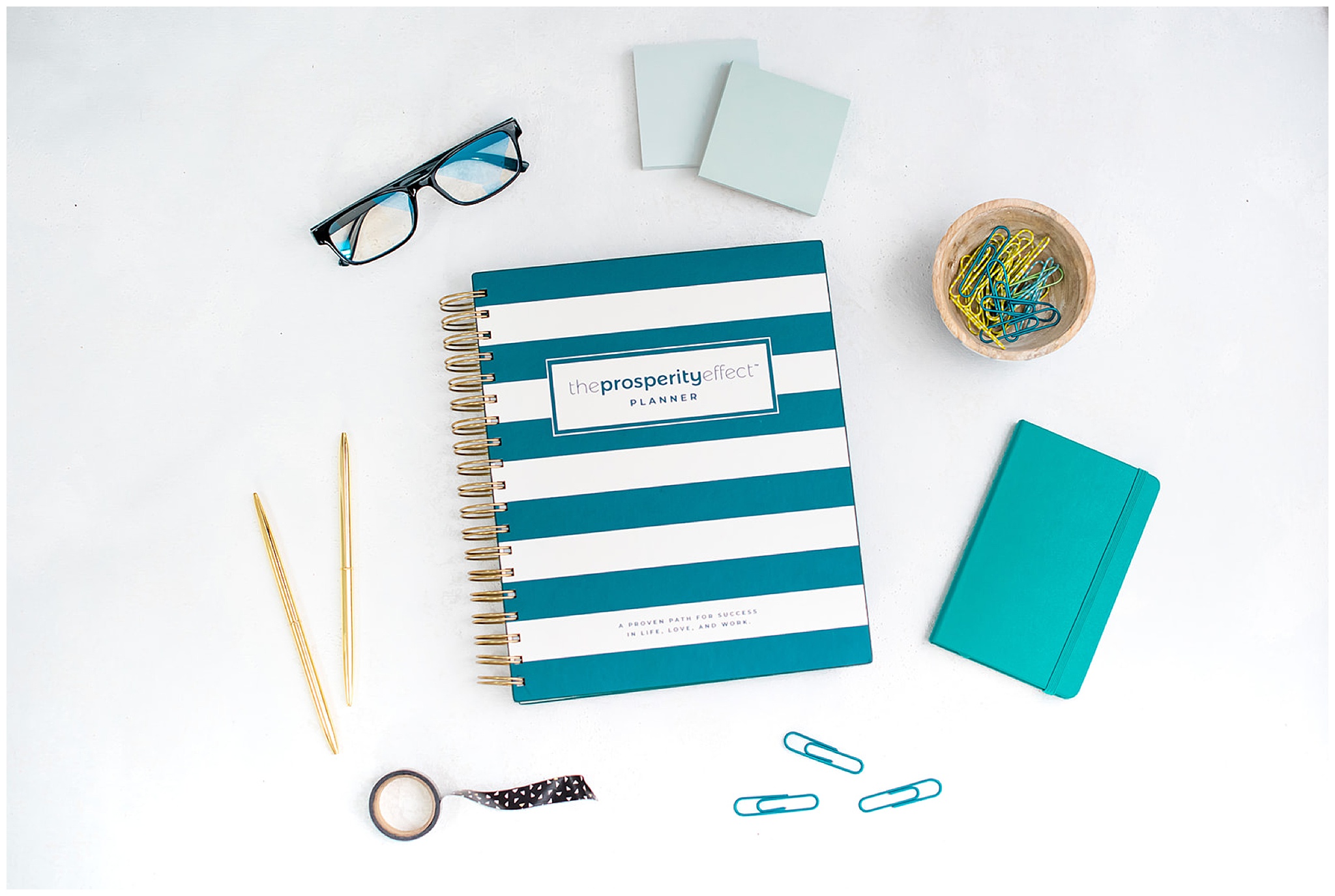 flatlay of prosperity effect planner with office items